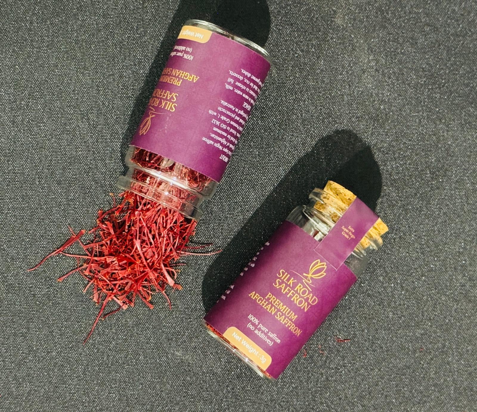 Silk Road Saffron 1g jar and loose red Afghan saffron threads displayed against a branded background.